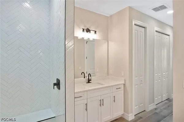 a bathroom with a double vanity sink and mirror