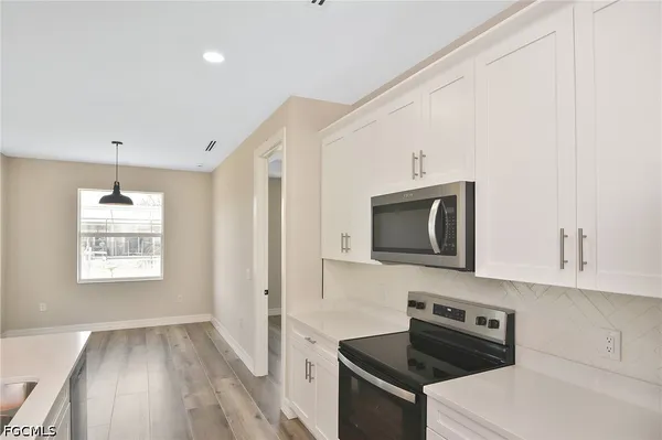 a kitchen with a stove and a microwave