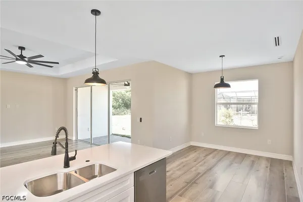 a kitchen with sink refrigerator and window