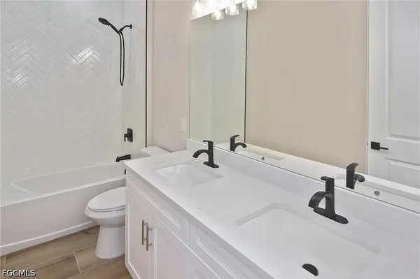 a bathroom with a sink a toilet and a tub