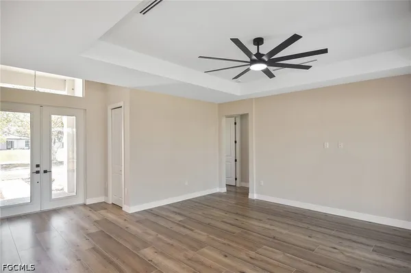 wooden floor in an empty room with a window