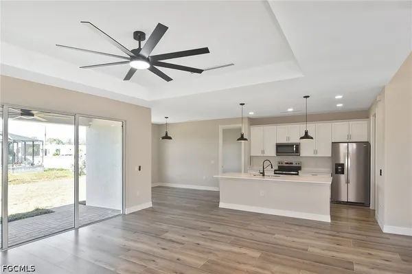 a view of a kitchen with a sink stainless steel appliances and cabinets