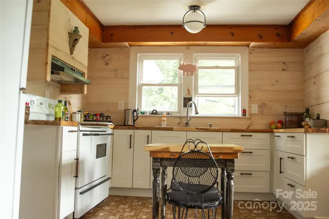 a kitchen that has a lot of cabinets in it and appliances