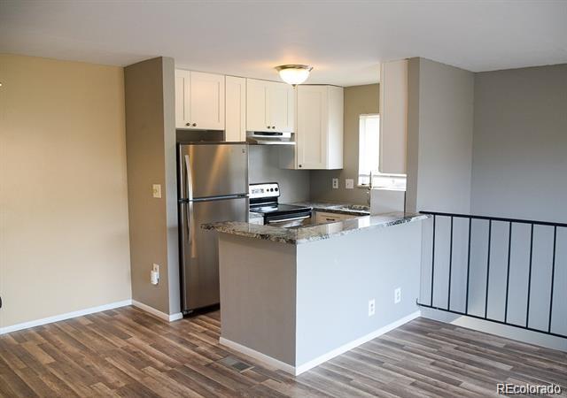 1225 South Oneida Street, Unit 252 Denver, CO 80224 - Photo 5 of 20 a kitchen with stainless steel appliances granite countertop a refrigerator and a stove top oven