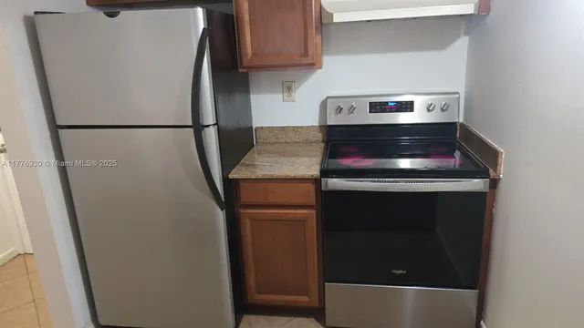 a kitchen with a refrigerator and a stove
