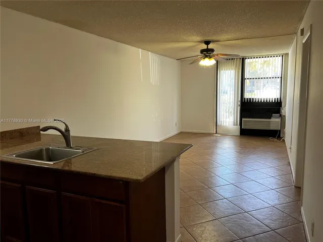 a kitchen with a sink a refrigerator and a stove