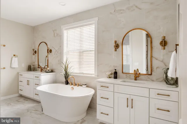 a bathroom with a tub sink and shower