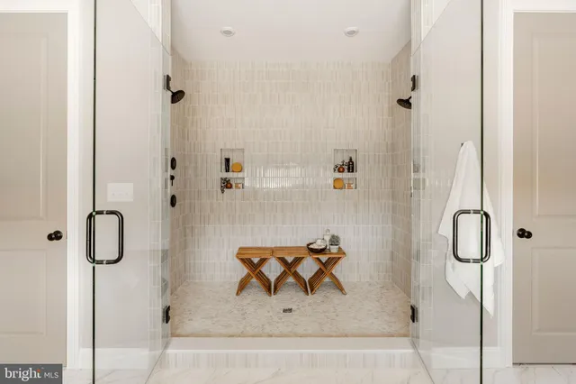 a spacious bathroom with a double vanity sink mirror and bathtub