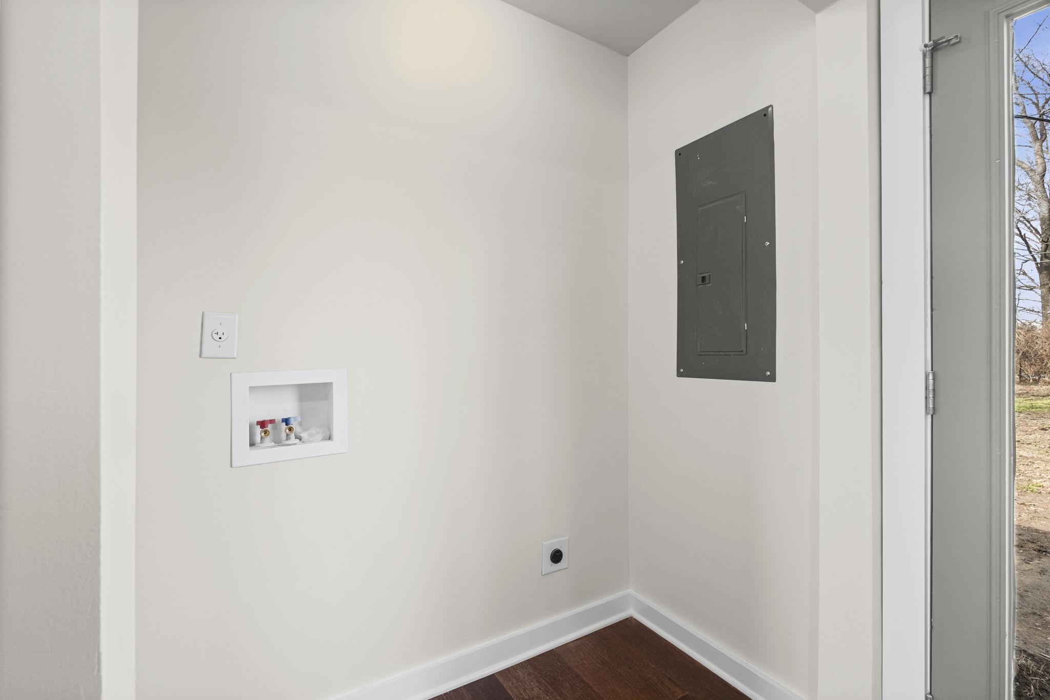 4774 Montgomery Road Millington, TN 38053 - Photo 16 of 20 Laundry area with electric panel, dark wood-style flooring, hookup for a washing machine, and plenty of natural light