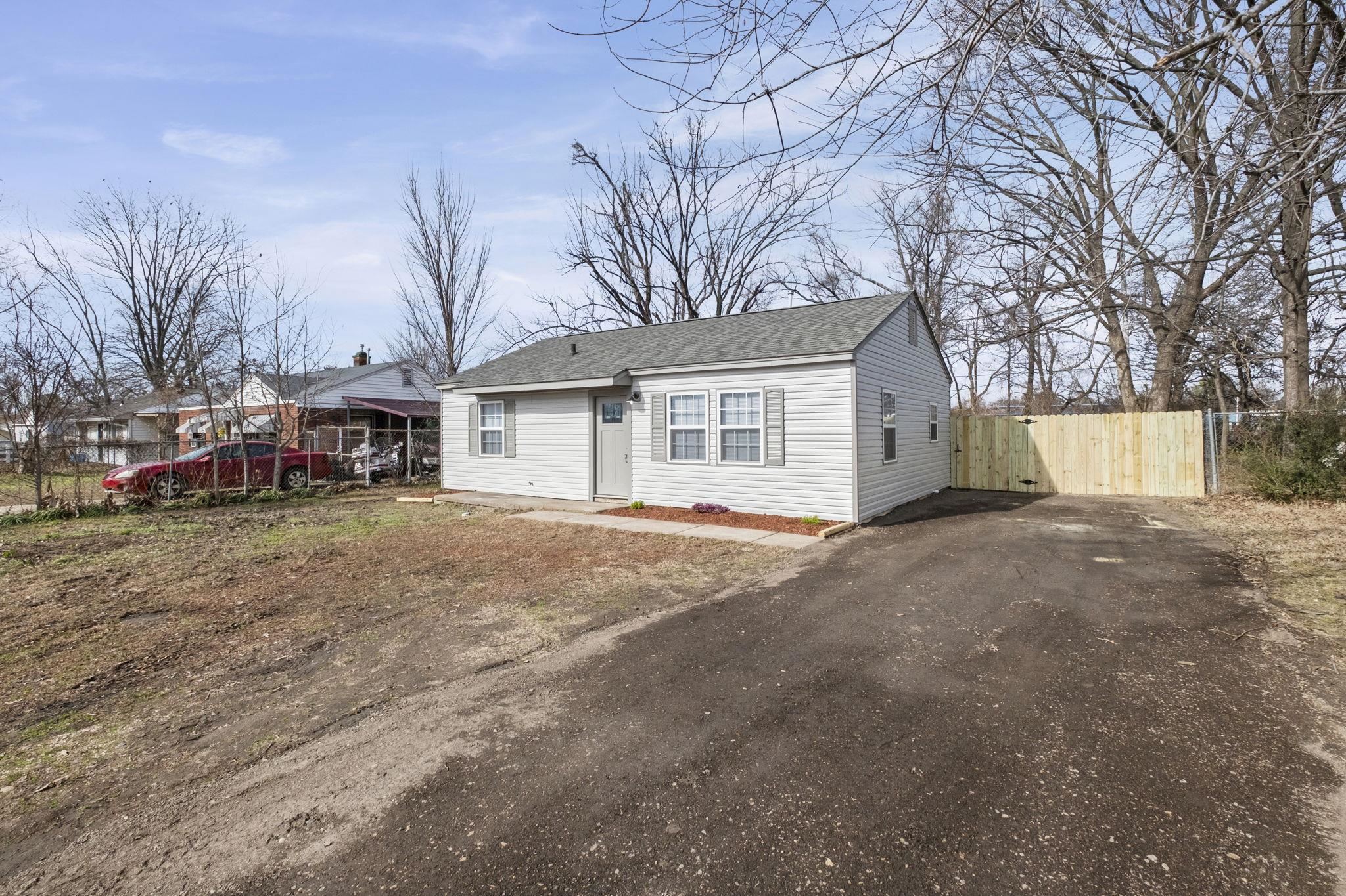 4774 Montgomery Road Millington, TN 38053 - Photo 2 of 20 Bungalow-style home featuring a shingled roof and asphalt driveway