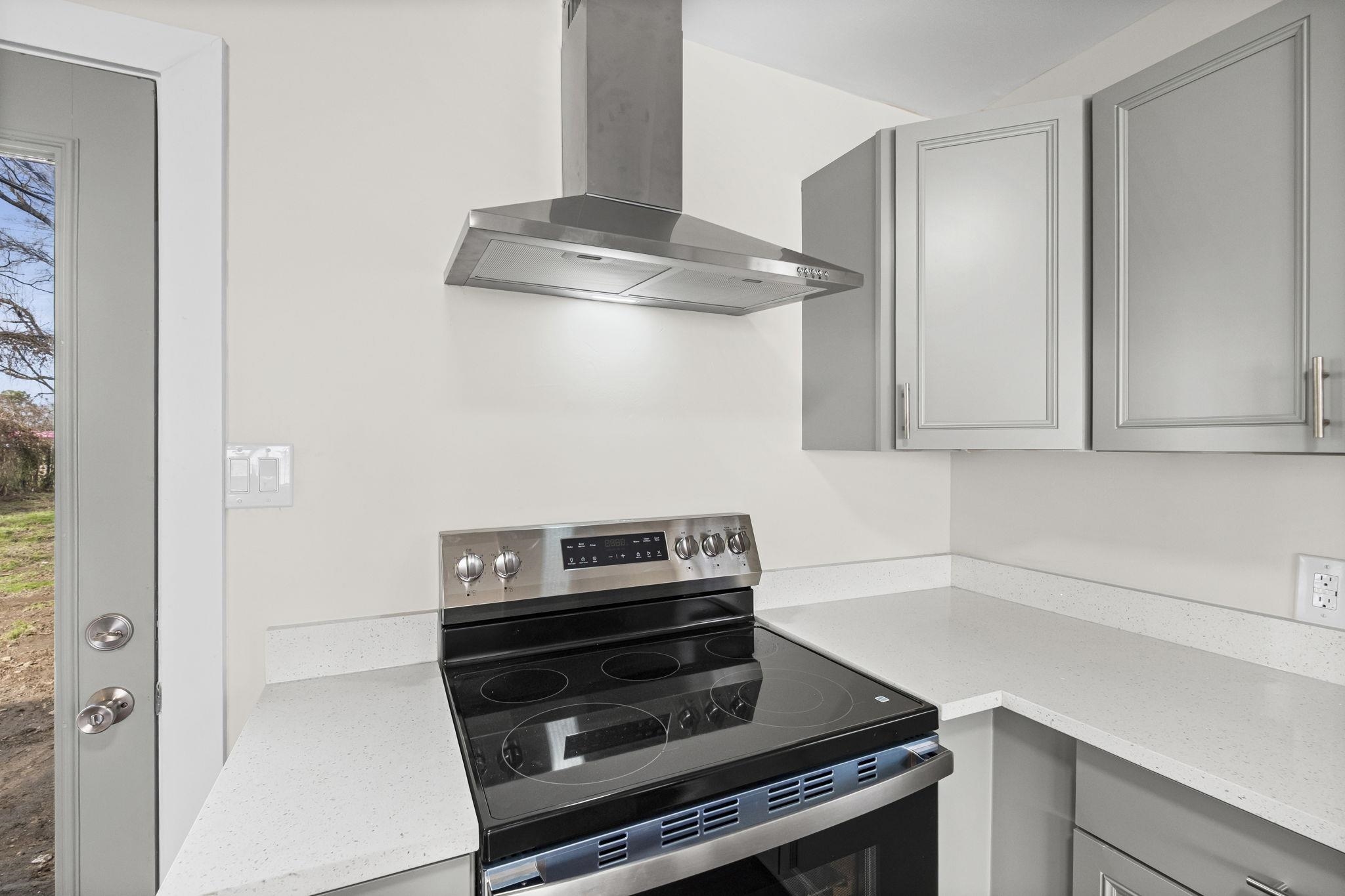 4774 Montgomery Road Millington, TN 38053 - Photo 9 of 20 Kitchen featuring gray cabinets, electric range, and light stone counters