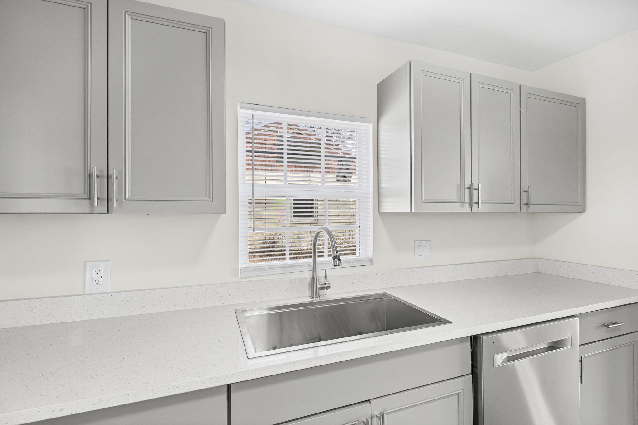 4774 Montgomery Road Millington, TN 38053 - Photo 10 of 20 Kitchen featuring gray cabinets, stainless steel dishwasher, and light stone counters