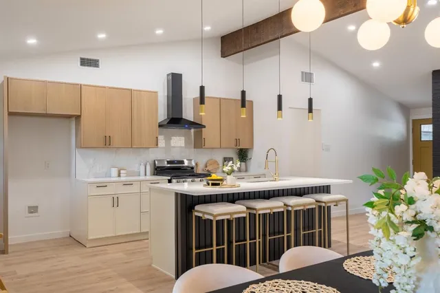 a kitchen with a table chairs sink and cabinets