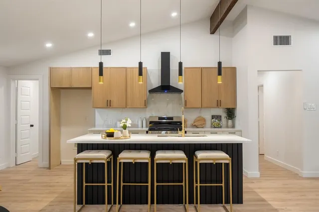 a kitchen with a sink appliances and cabinets
