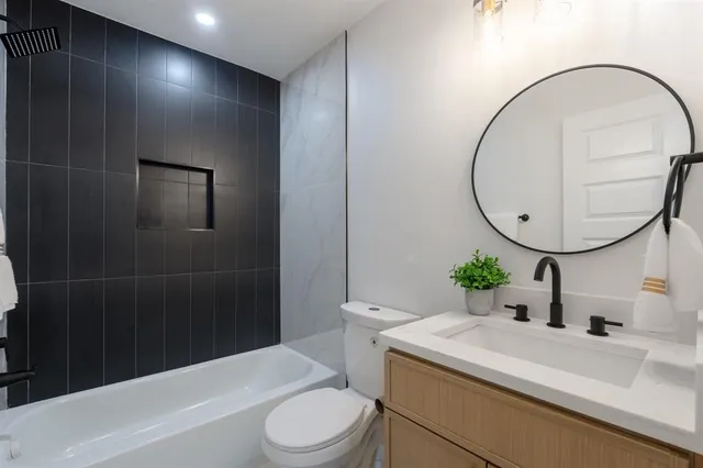 a bathroom with a sink a toilet and a mirror