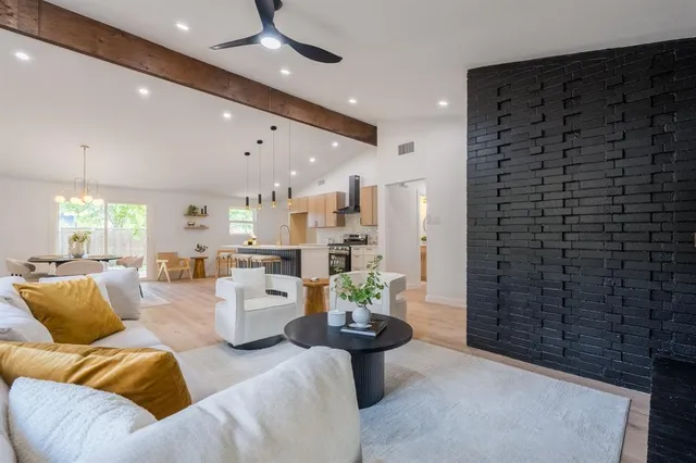 a living room with furniture and a chandelier