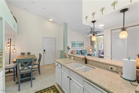 a view of a dining room with furniture and a kitchen