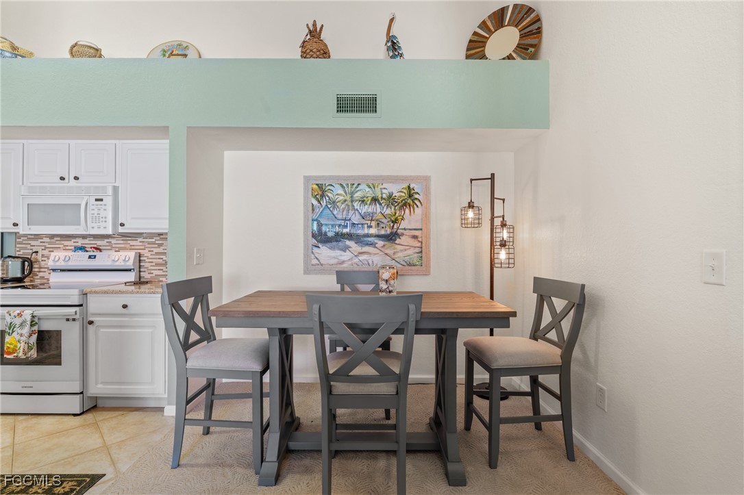 4149 Residence Drive, Unit 824 Fort Myers, FL 33901 - Photo 14 of 25 a view of a dining room that has a table and chair in it