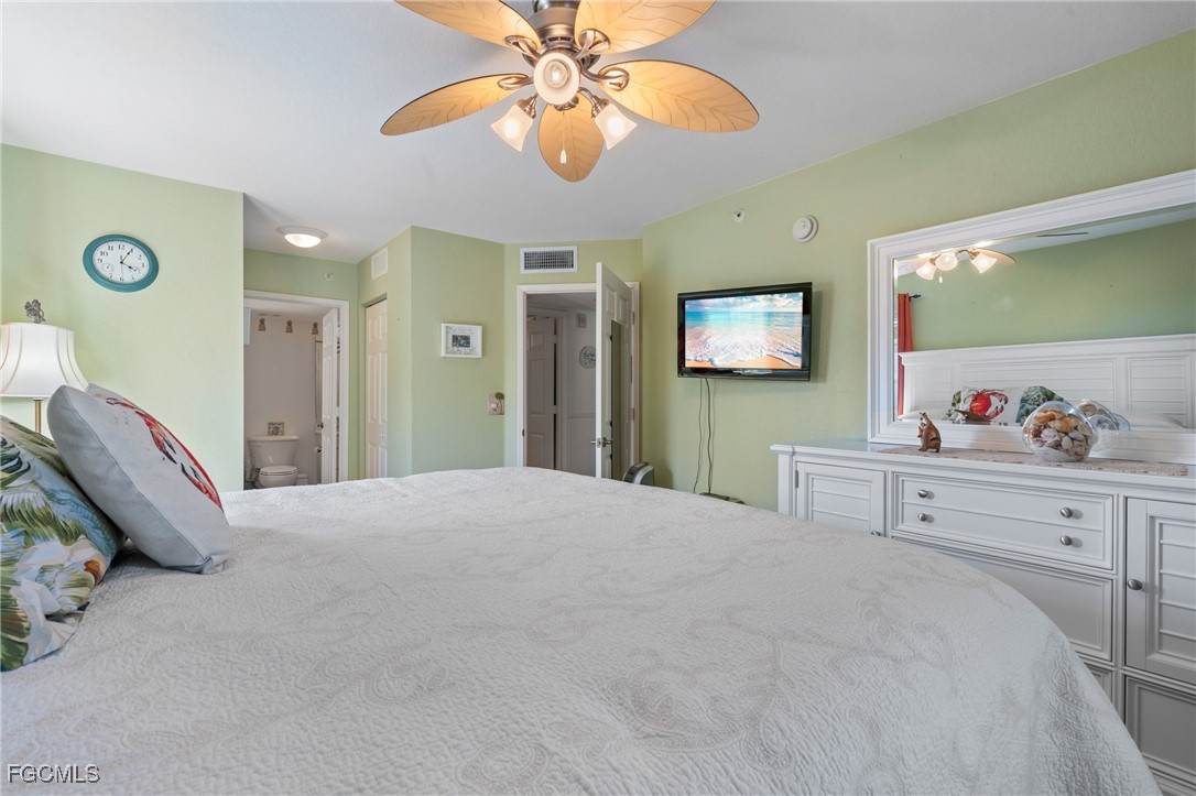 4149 Residence Drive, Unit 824 Fort Myers, FL 33901 - Photo 16 of 25 a bedroom with a bed and a chandelier