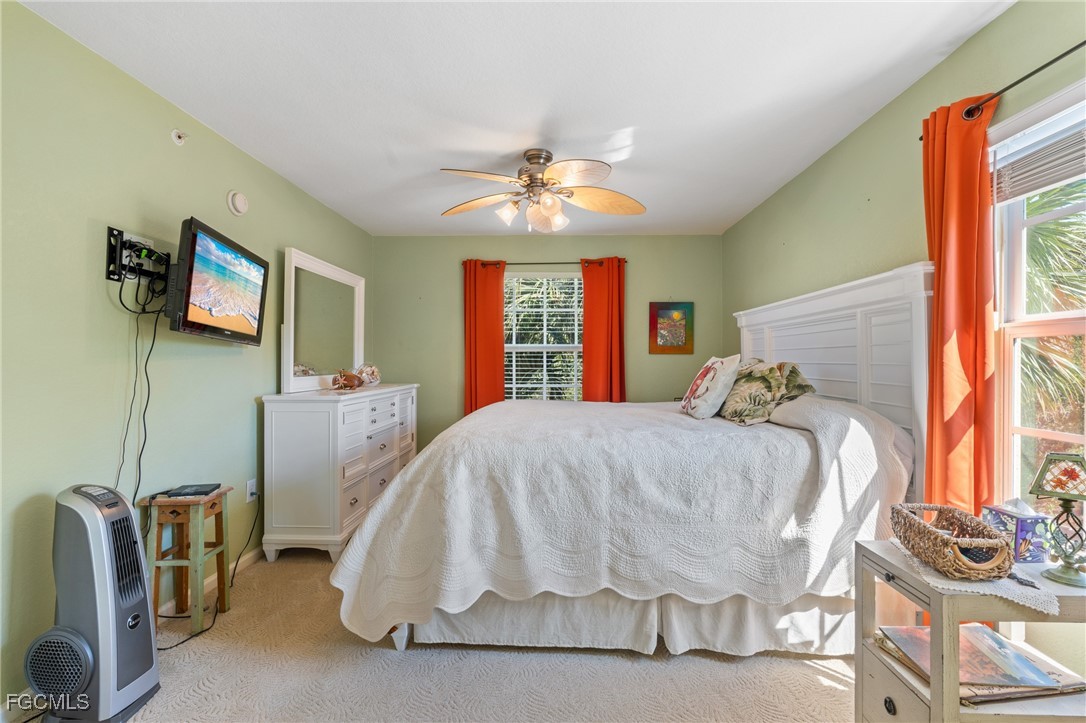 4149 Residence Drive, Unit 824 Fort Myers, FL 33901 - Photo 17 of 25 a bed sitting in a bedroom next to a window
