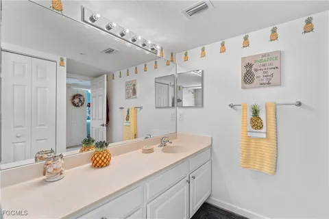 a bathroom with a double vanity sink toilet and shower