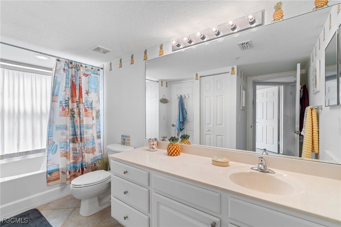 4149 Residence Drive, Unit 824 Fort Myers, FL 33901 - Photo 19 of 25 a bathroom with a double vanity sink toilet and shower