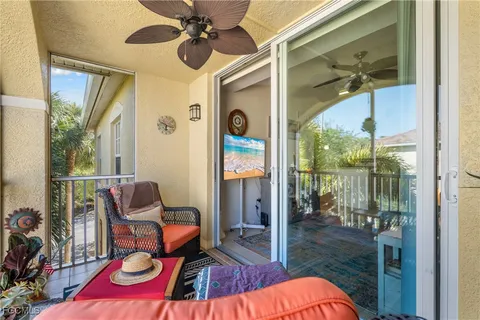 a balcony with furniture and a potted plant