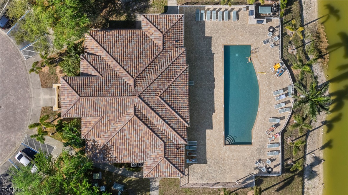 4149 Residence Drive, Unit 824 Fort Myers, FL 33901 - Photo 24 of 25 an aerial view of a house with a yard and potted plants
