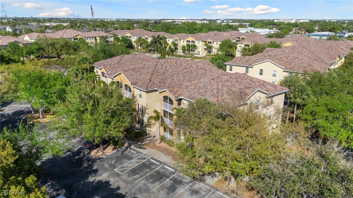4149 Residence Drive, Unit 824 Fort Myers, FL 33901 - Photo 3 of 25 an aerial view of a house with a yard and lake view