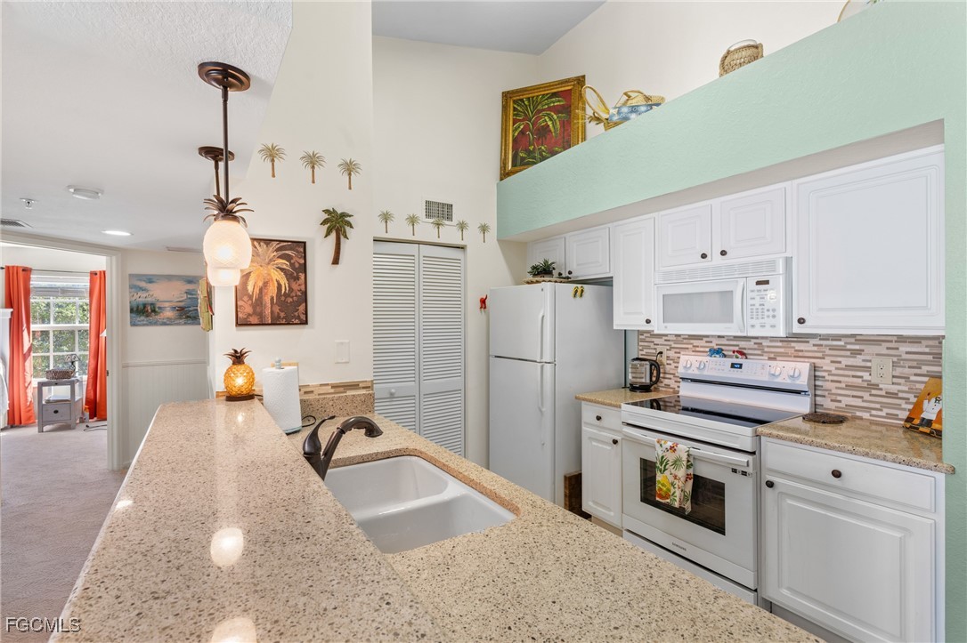 4149 Residence Drive, Unit 824 Fort Myers, FL 33901 - Photo 8 of 25 a kitchen with a refrigerator and a sink