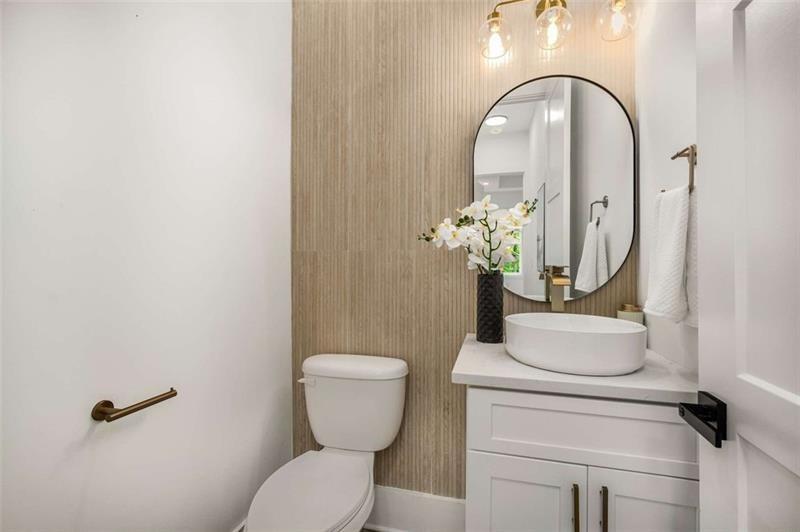7262 Creekside Way Jefferson, GA 30549 - Photo 19 of 52 a bathroom with a toilet sink and mirror