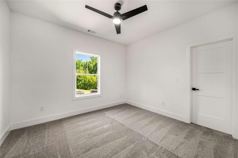 7262 Creekside Way Jefferson, GA 30549 - Photo 34 of 52 a view of room with window hardwood floor and a ceiling fan