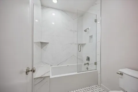 a bathroom with a bathtub and a shower