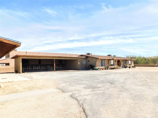 a view of houses with snow on the side of the road