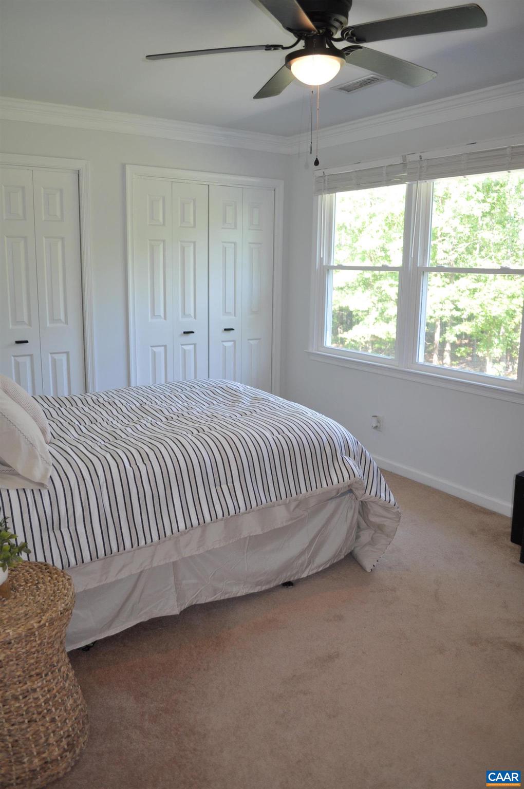 3257 Martin Kings Road Charlottesville, VA 22902 - Photo 29 of 49 a bed sitting in a bedroom next to a window