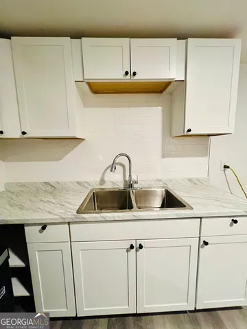 a kitchen with a sink and cabinets