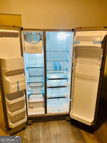 a view of walk in closet with empty racks