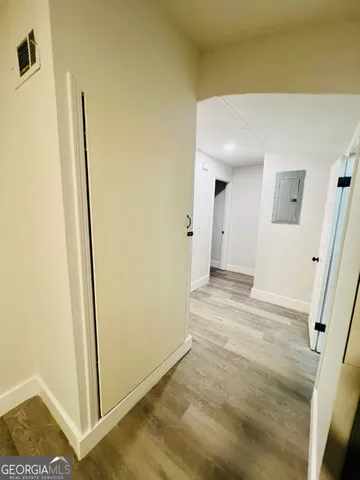 a view of a hallway to rooms