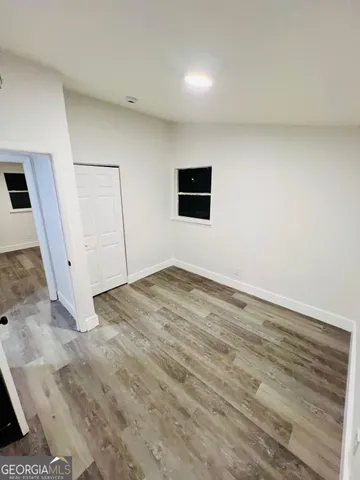 a view of a livingroom with wooden floor and window