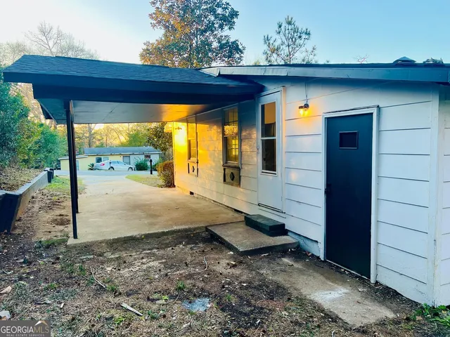 a view of a porch with a table and chairs