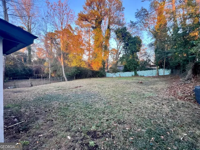 a view of a backyard with large trees