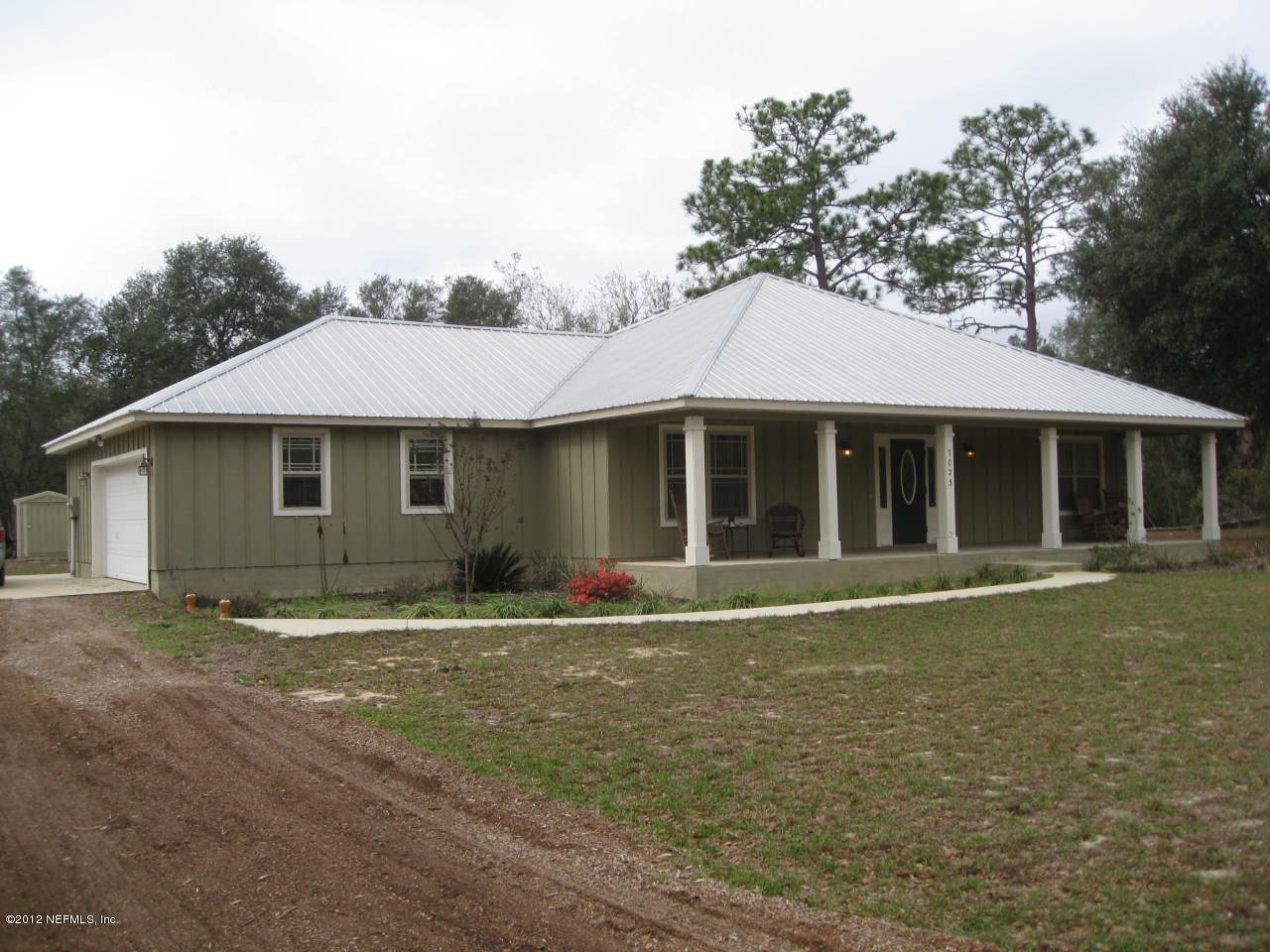 7023 Elfo Road Keystone Heights, FL 32656 - Photo 1 of 12 a front view of a house with a garden