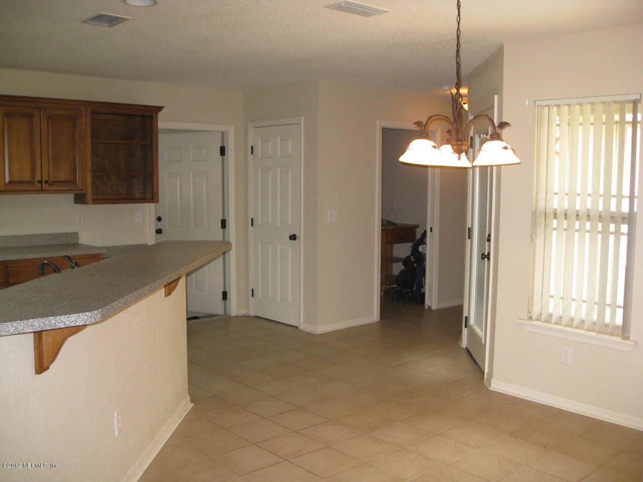 7023 Elfo Road Keystone Heights, FL 32656 - Photo 5 of 12 a kitchen that has a sink a window and cabinets