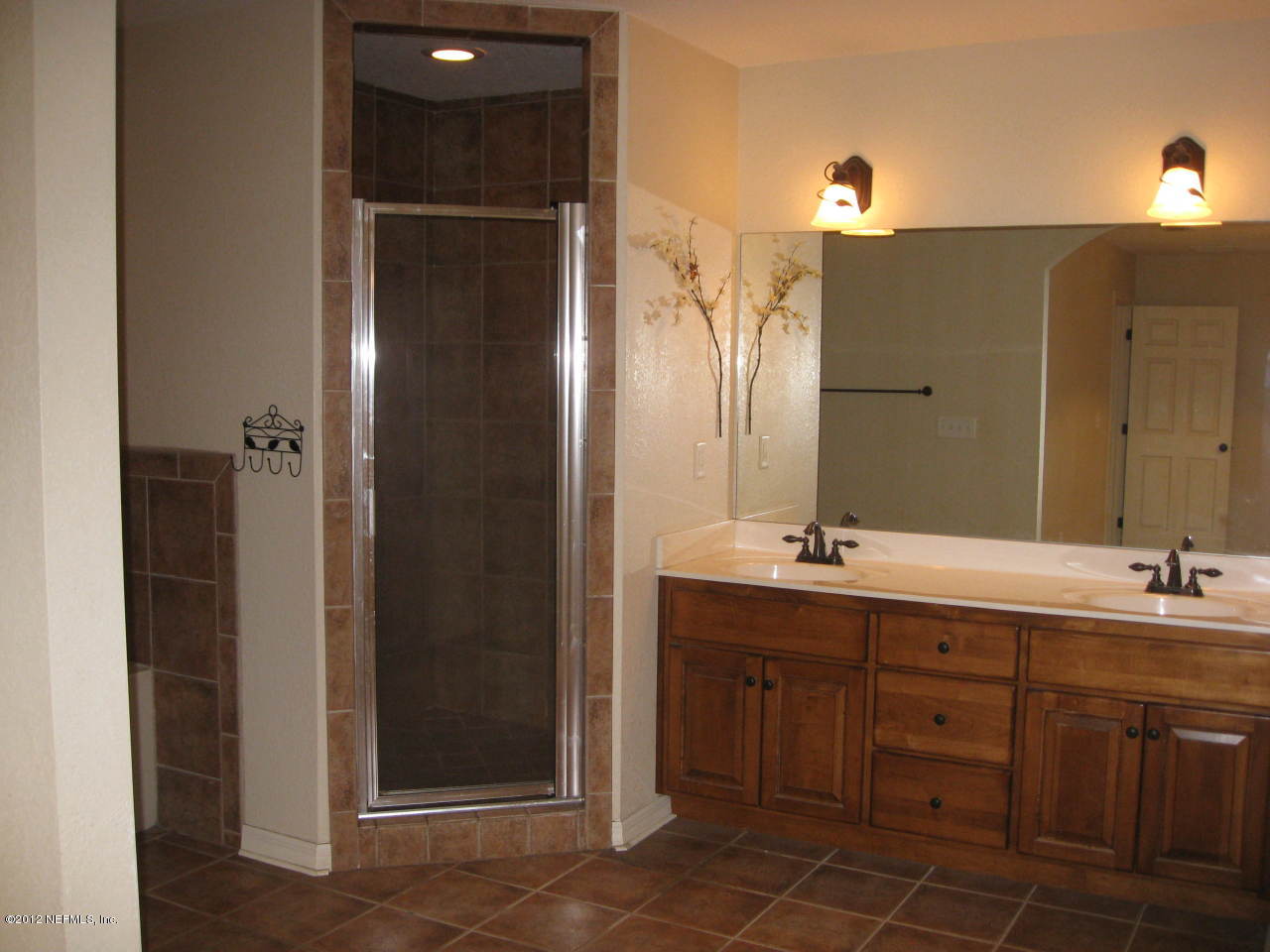 7023 Elfo Road Keystone Heights, FL 32656 - Photo 6 of 12 a bathroom with a double vanity sink and mirror