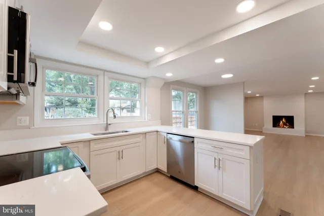a kitchen with sink attached with living room