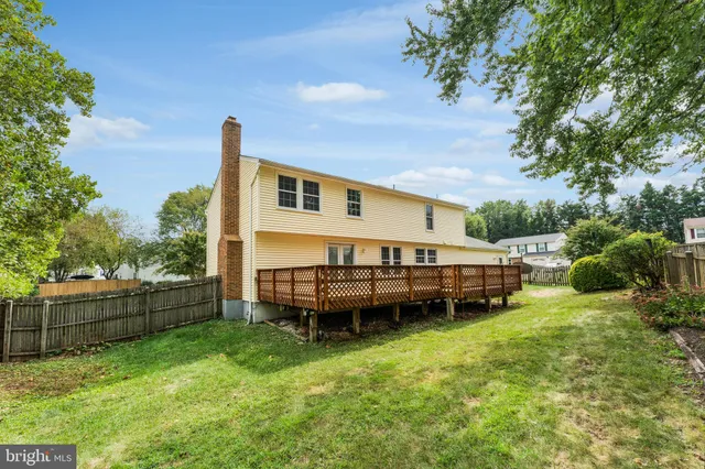 a backyard of a house with a garden and deck