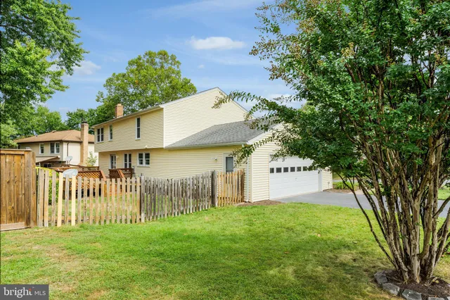 a front view of a house with a garden and fence