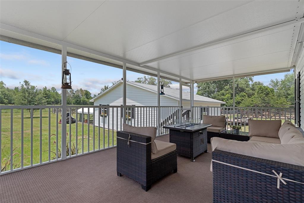 26255 Lambeth Road Brooksville, FL 34601 - Photo 50 of 76 a view of a balcony with couches and wooden floor