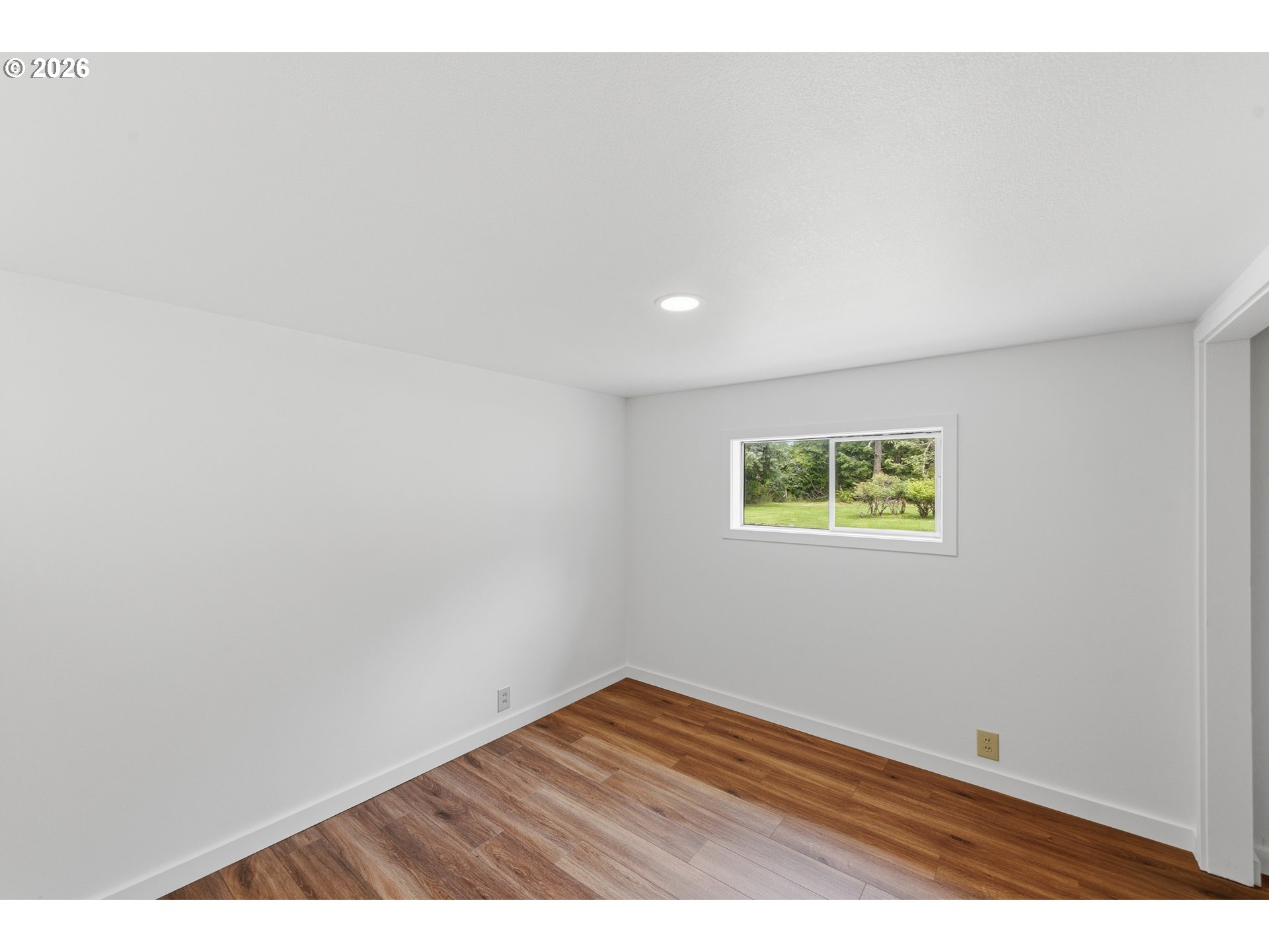 63299 Wildahl Road Coos Bay, OR 97420 - Photo 29 of 45 an empty room with wooden floor and windows