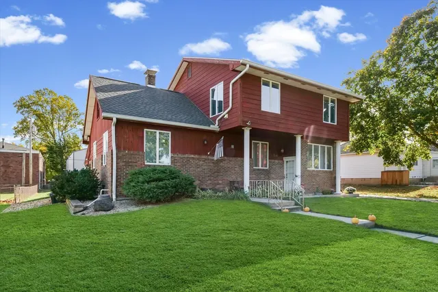 a front view of a house with a garden and yard
